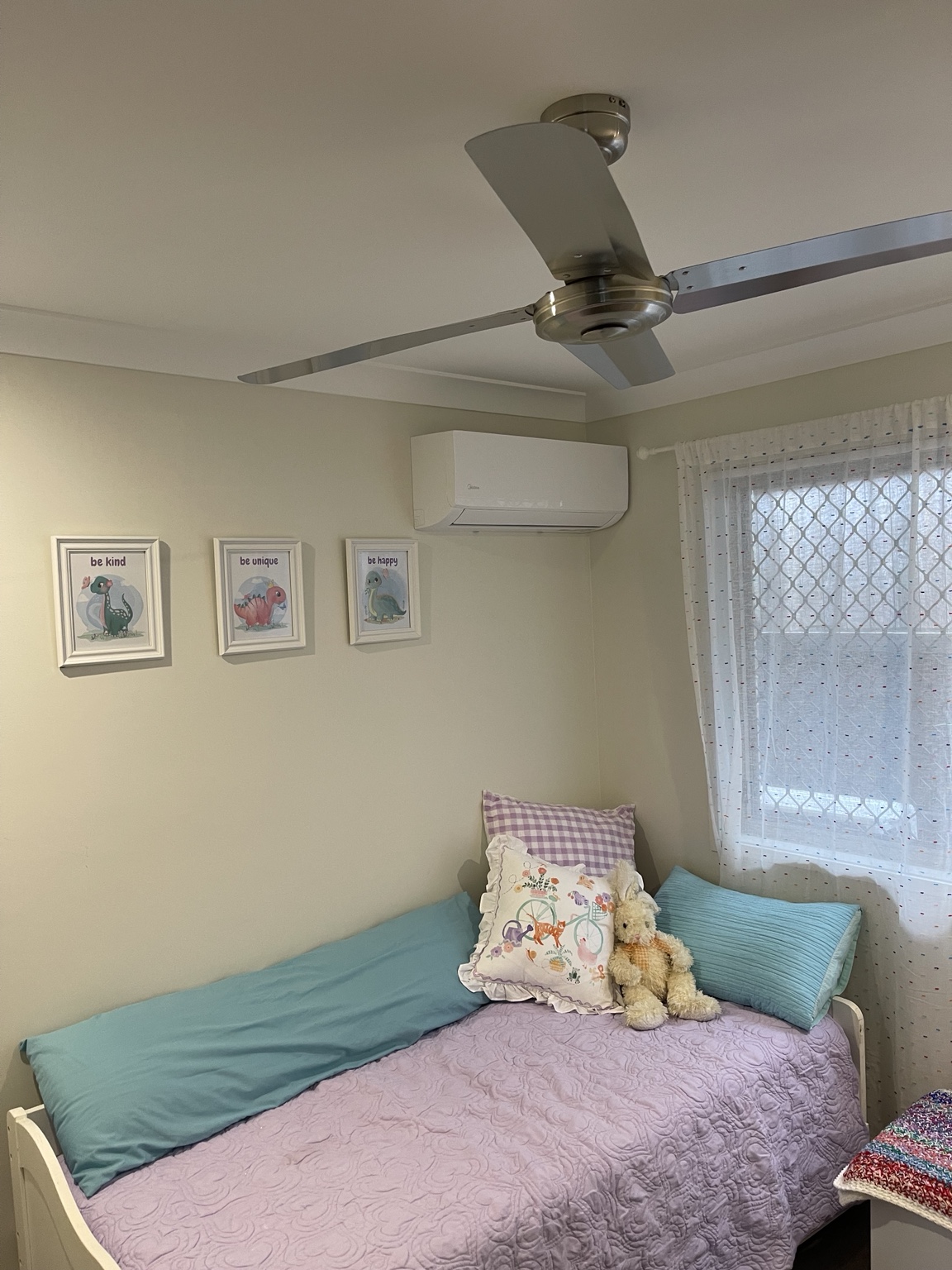 Midea split system in a bedroom with side-exit pipe cover