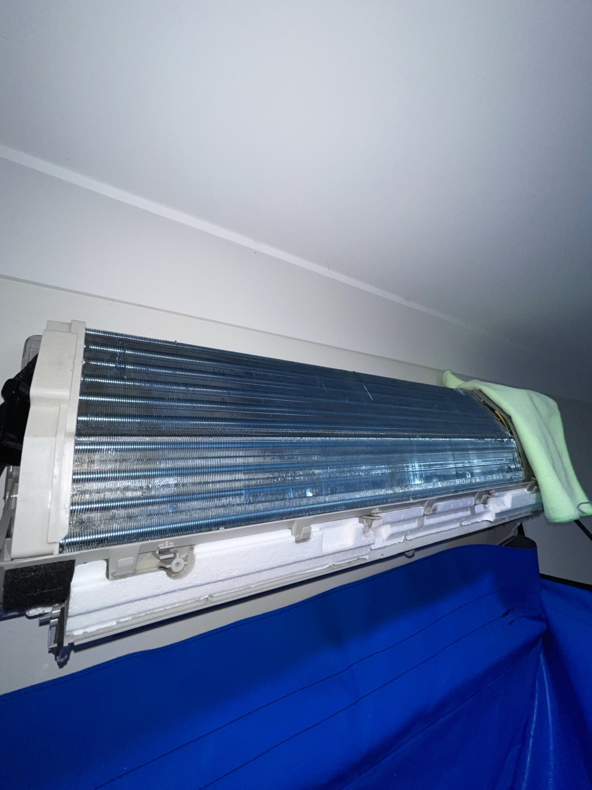 Indoor air conditioner opened for cleaning with a cleaning bag