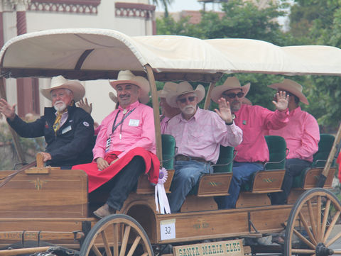 Elks members riding on a horse-drawn carriage in 2023 parade.