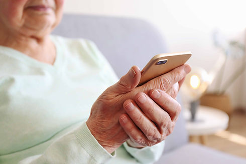 SMM-elderly-holding-phone-messages.jpg