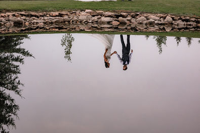 pond reflection of bride and groom