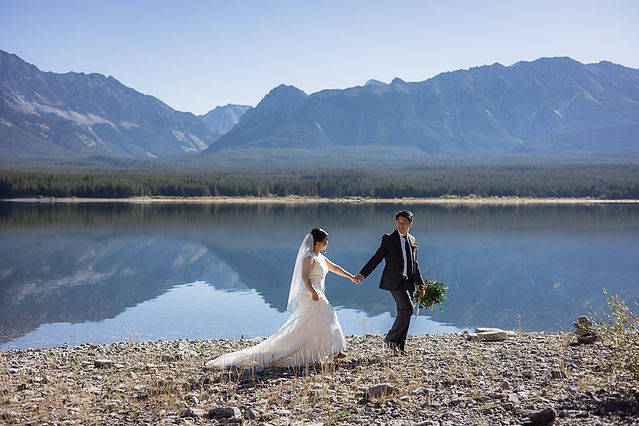 Bride and Groom hold hands while walking 