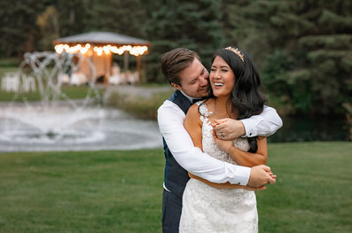 bride and groom laughing at pine and pond