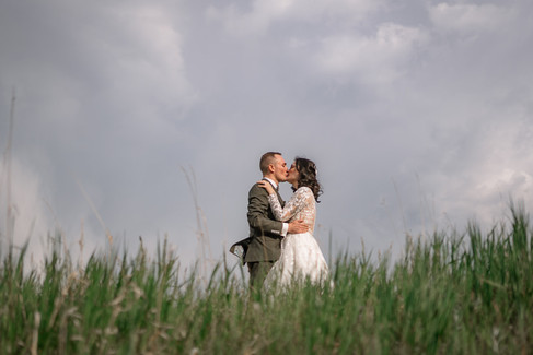 Couple kissing with moody skies
