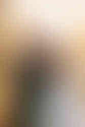 bride puts her head on grooms shoulder from behind in sunset