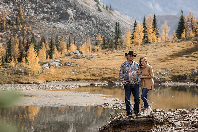 Couple smile beside each other in Kananaskis 