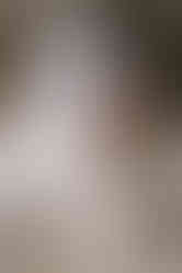 Bride and groom sharing an intimate moment beside a waterfall in Fernie, standing on rocky terrain on their Crowsnest Pass wedding day