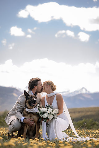 Bride and groom sharing a kiss with their dog at an Airbnb wedding venue