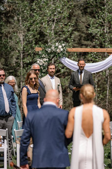 Groom watching the bride arrive during a Bragg Creek Airbnb wedding ceremony
