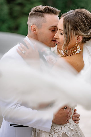 man kisses his bride's cheek