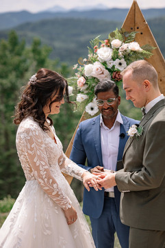 groom putting ring bride during ceremony