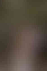 Bride and groom embracing together against a rocky backdrop on their Crowsnest Pass wedding day