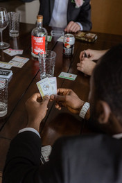 Detail shot of groomsmen playing card games