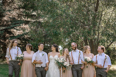 bride and groom walking with wedding party
