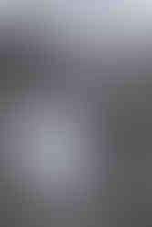 Black and white candid of the bride and groom walk hand and hand across the lawn at Diamond in the Rough, laughing together