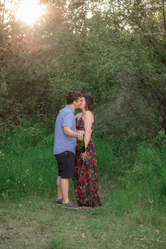 The couple share a kiss, after opening the bottle of champagne to celebrate their engagement