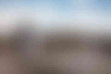 Landscape shot of bride and groom looking at each other in the hoodoos