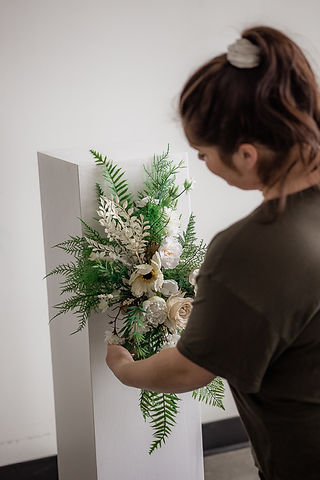 Florist arranging cream fake flowers 