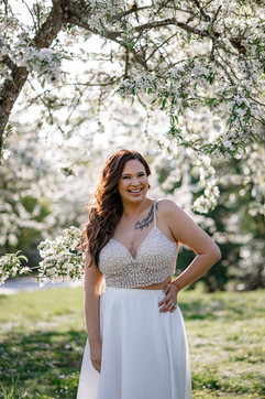 Bride smiling during photos in blossoms
