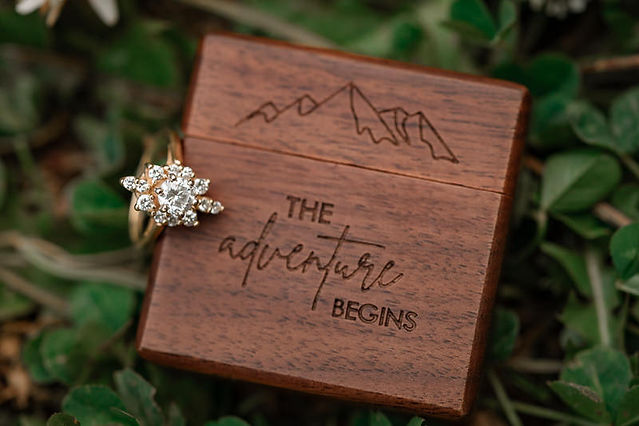 custom ring box with the adventure begins on it