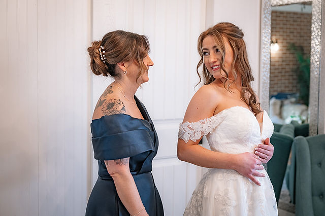 Bride sharing a special moment with a bridesmaid while getting ready for a Cork and Crate wedding
