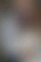 Detail shot of brides wedding ring hand on grooms chest