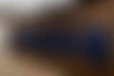 Groomsmen and grooms jackets all hung up in the wooden locker room