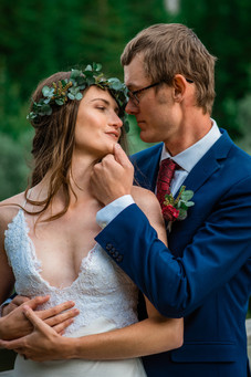 Groom touching his bride's chin gazing at one another.