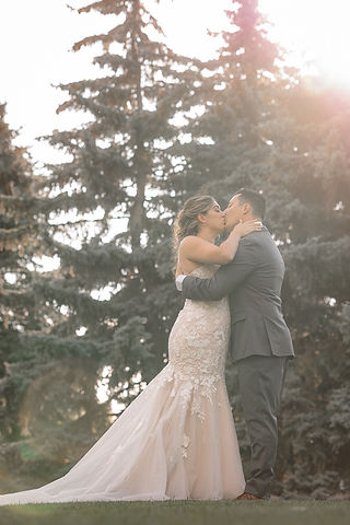 Bride and groom kissing at golden hour