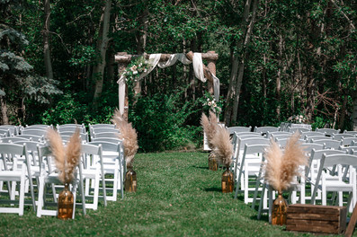 ceremony location prior to any guests arriving, pampas grass, white chairs, 