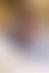 groom kisses bride as she smiles