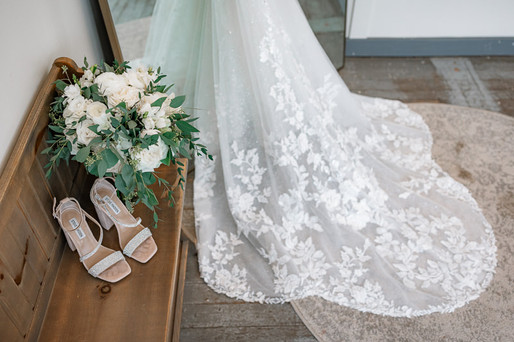 Bridal detail shot of the train, bridal shoes and florals
