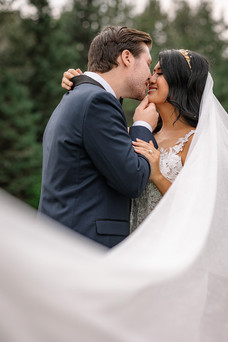 Veil shot with couple kissing in background