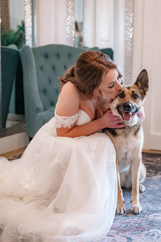 bride kissing her pup
