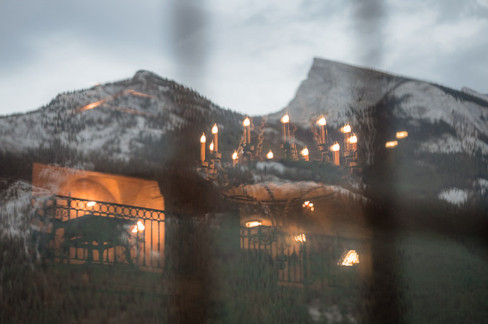 rocky mountains out the window with reflection of the reception lighting 