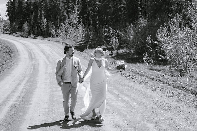 Black and white portrait of newlyweds holding hands after a Bragg Creek wedding