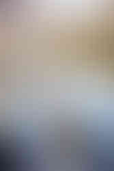 Bride smiles beside mountain lake