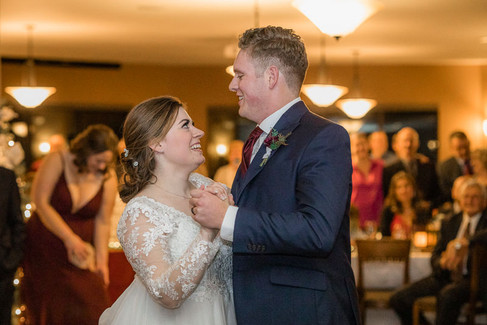 Bride and groom during first dance smiling at one another