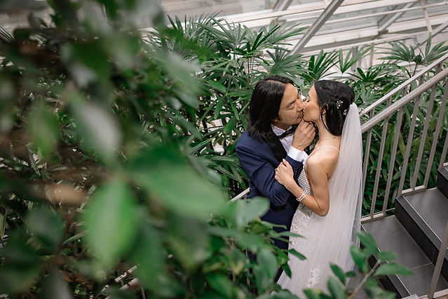 bride and groom kissing on staircase