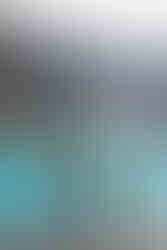 couple hold hands and look out over stunning lake