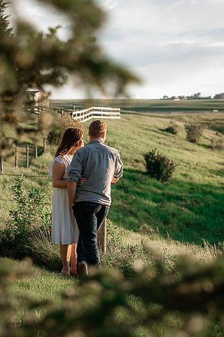 Couple looking over meadow, looking into sunset, sunset, summer, engagement photos