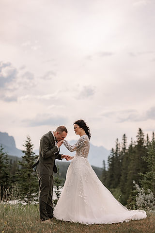 groom kissing brides hand
