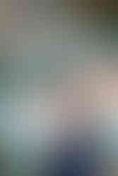 Alpine glow on moraine lake as couple looks out into the still waters reflection