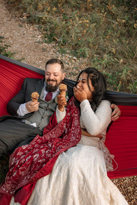 bride and groom in hammock eating ice cream cones