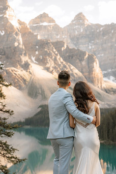 Couple posing together with mountains in the background