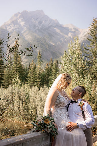 Bride and Groom photos on bridge in rocky mountains 