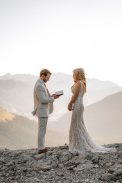 Groom reading vows on a mountain top