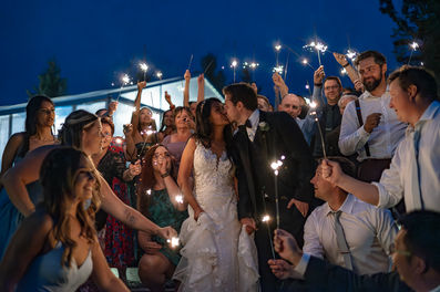 sparkler exit with guests, bride and groom kissing