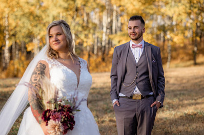 groom looks at bride as bride looks into the sunset