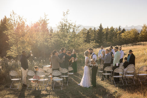 fall wedding ceremony with couple kissing